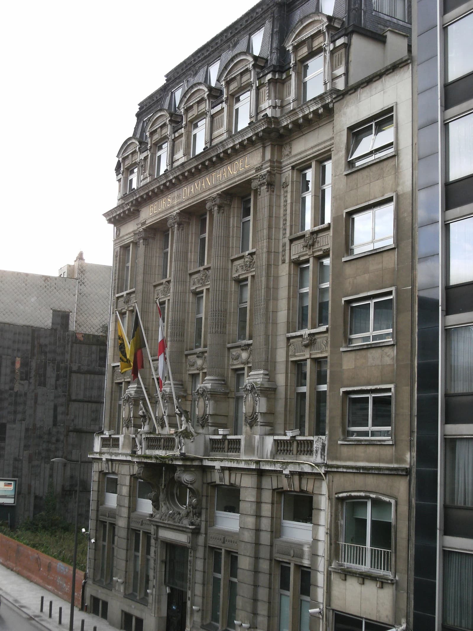 Diamond Exchange building exterior in Antwerp, Belgium, with flags displayed.