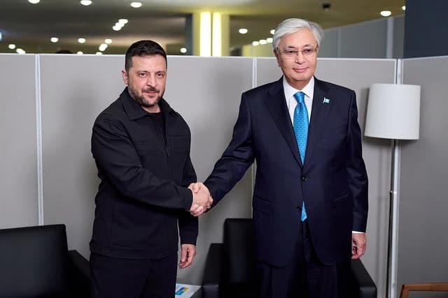 Ukrainian President Volodymyr Zelenskyy shaking hands with Kazakh President Kassym-Jomart Tokayev.