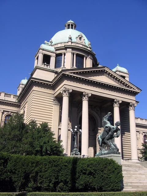 Serbian National Assembly building, a large domed structure with classical columns.