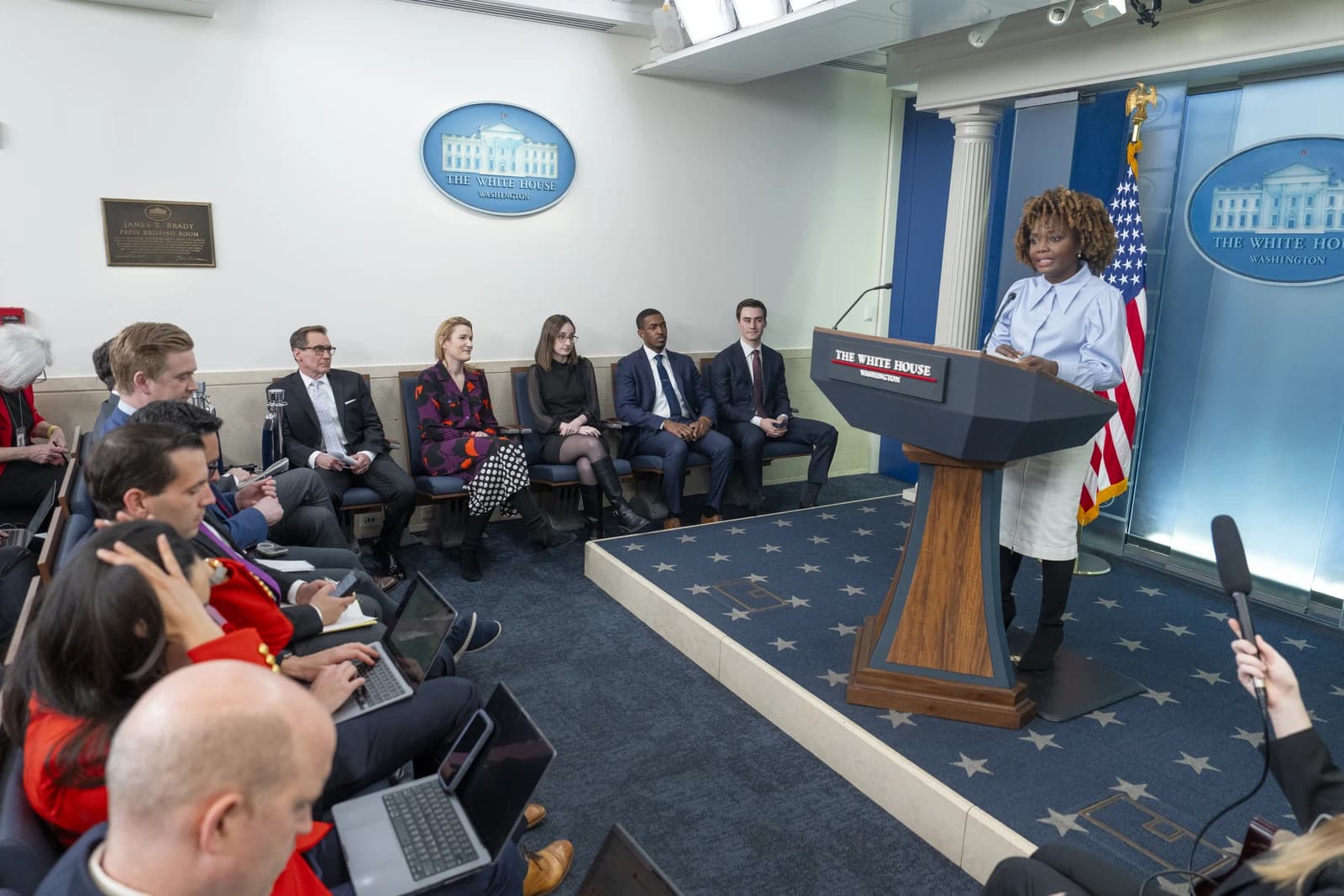 Karine Jean-Pierre, Press Secretary, speaking at a podium in the White House.