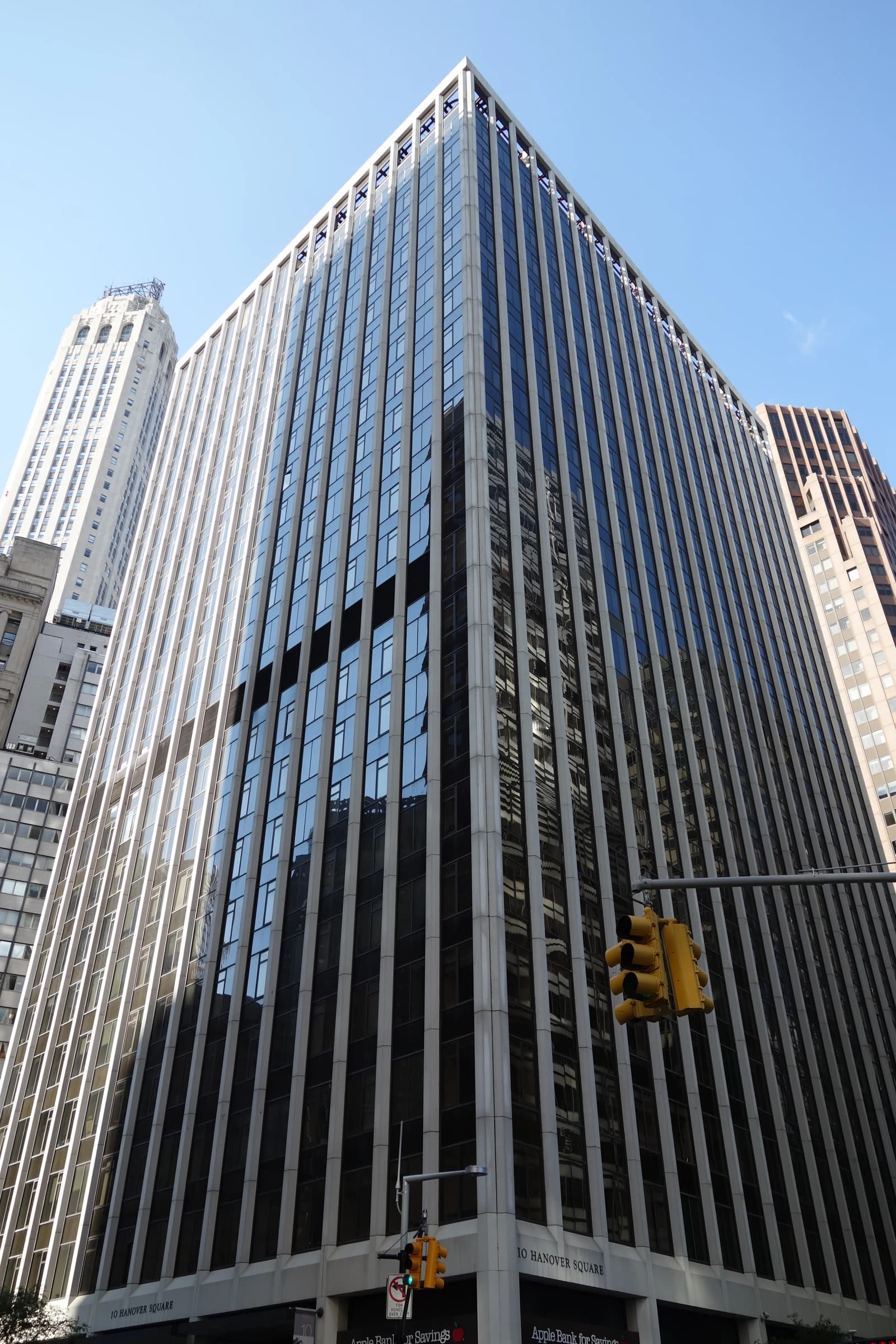 Skyscraper at 10 Hanover Square in New York City with traffic light.