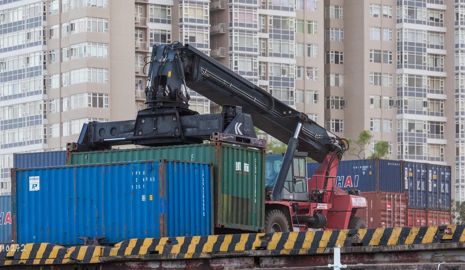 Shipping containers being loaded by a crane at a port in Ho Chi Minh City.