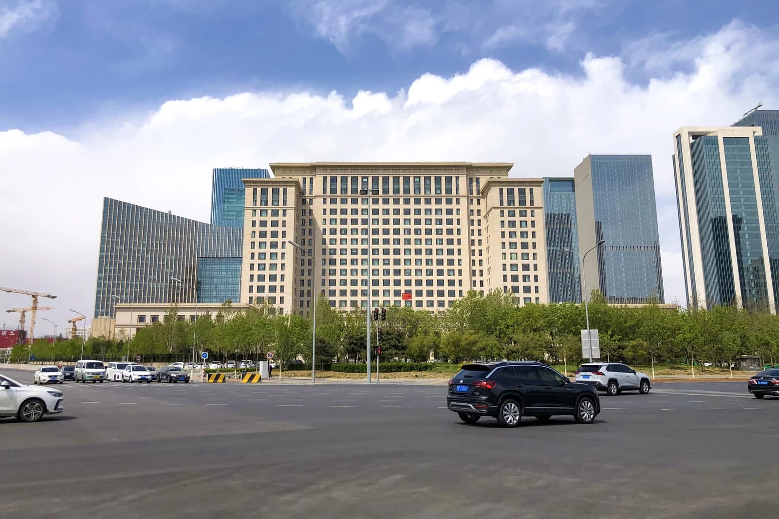Exterior view of the National Audit Office of China building with traffic in foreground.