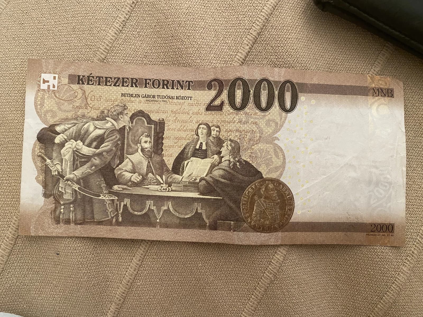 A 2000 Hungarian Forint banknote lying on a textured surface.