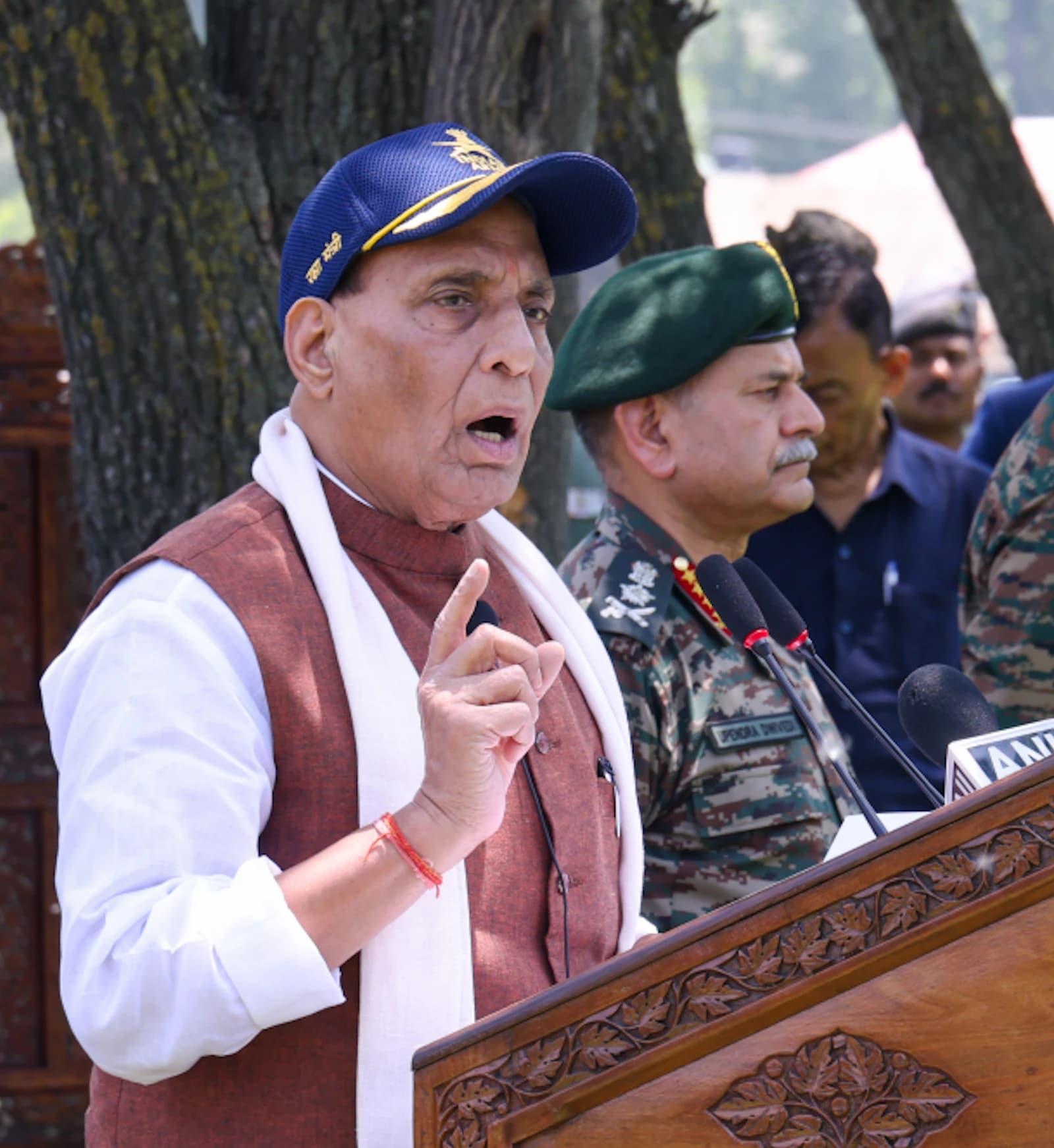 Rajnath Singh, Minister of Defence, speaking at a podium outdoors to Indian Army soldiers.