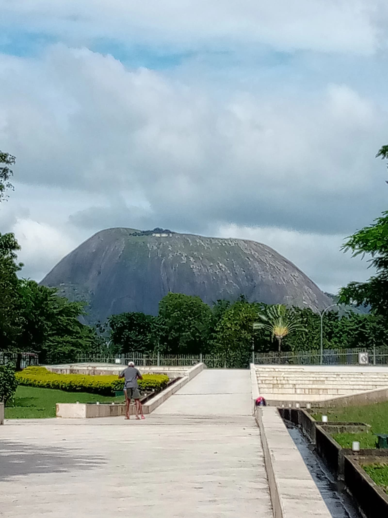 Aso Rock, a large inselberg in Abuja, Nigeria, with government buildings at its base.