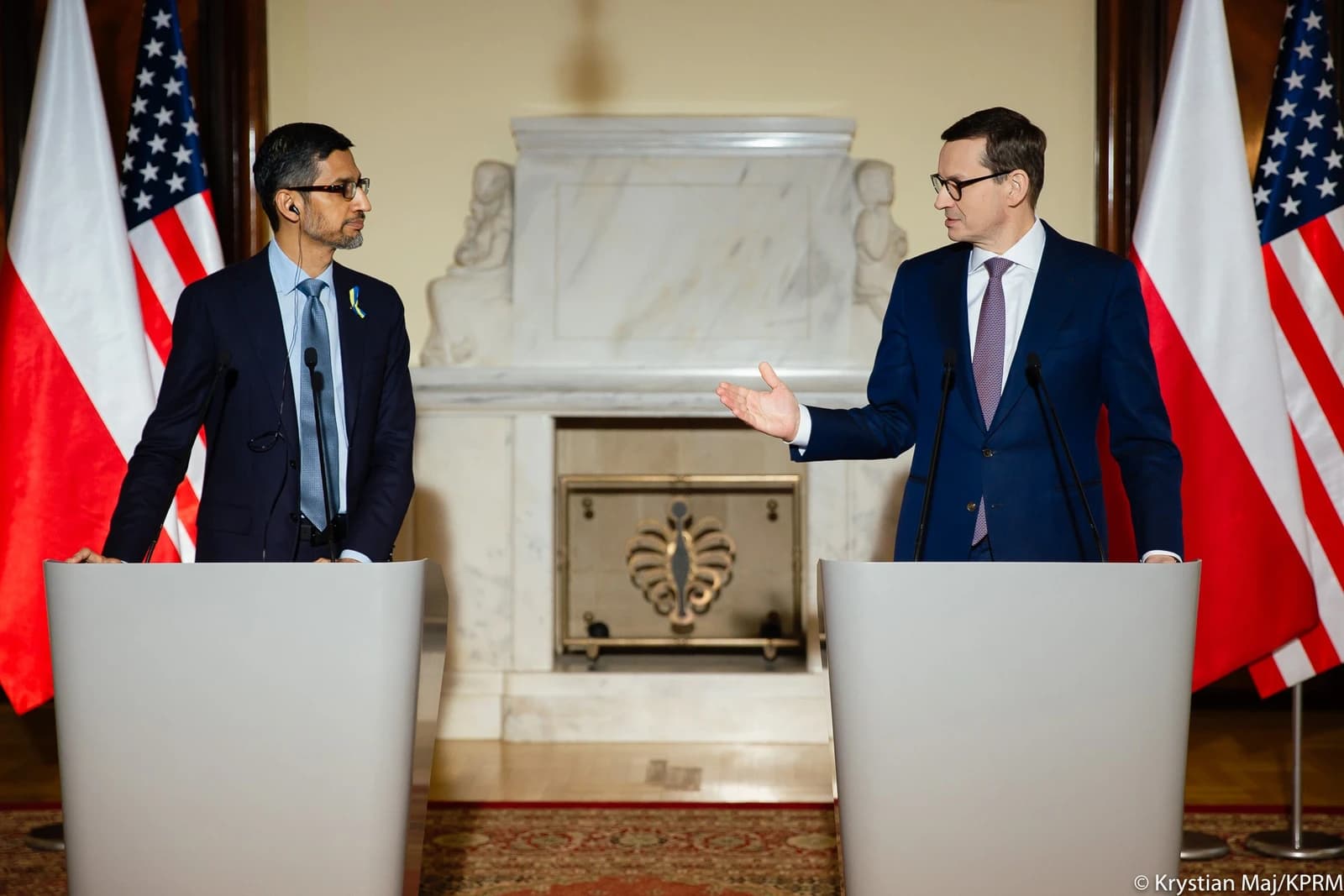 Sundar Pichai, Google CEO, stands beside Mateusz Morawiecki, Polish Prime Minister, at a podium.