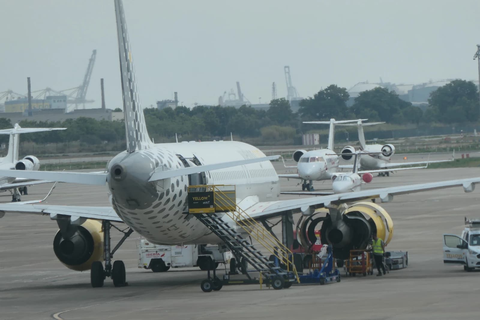 Vueling Airbus aircraft parked on the tarmac at Barcelona-El Prat Airport.