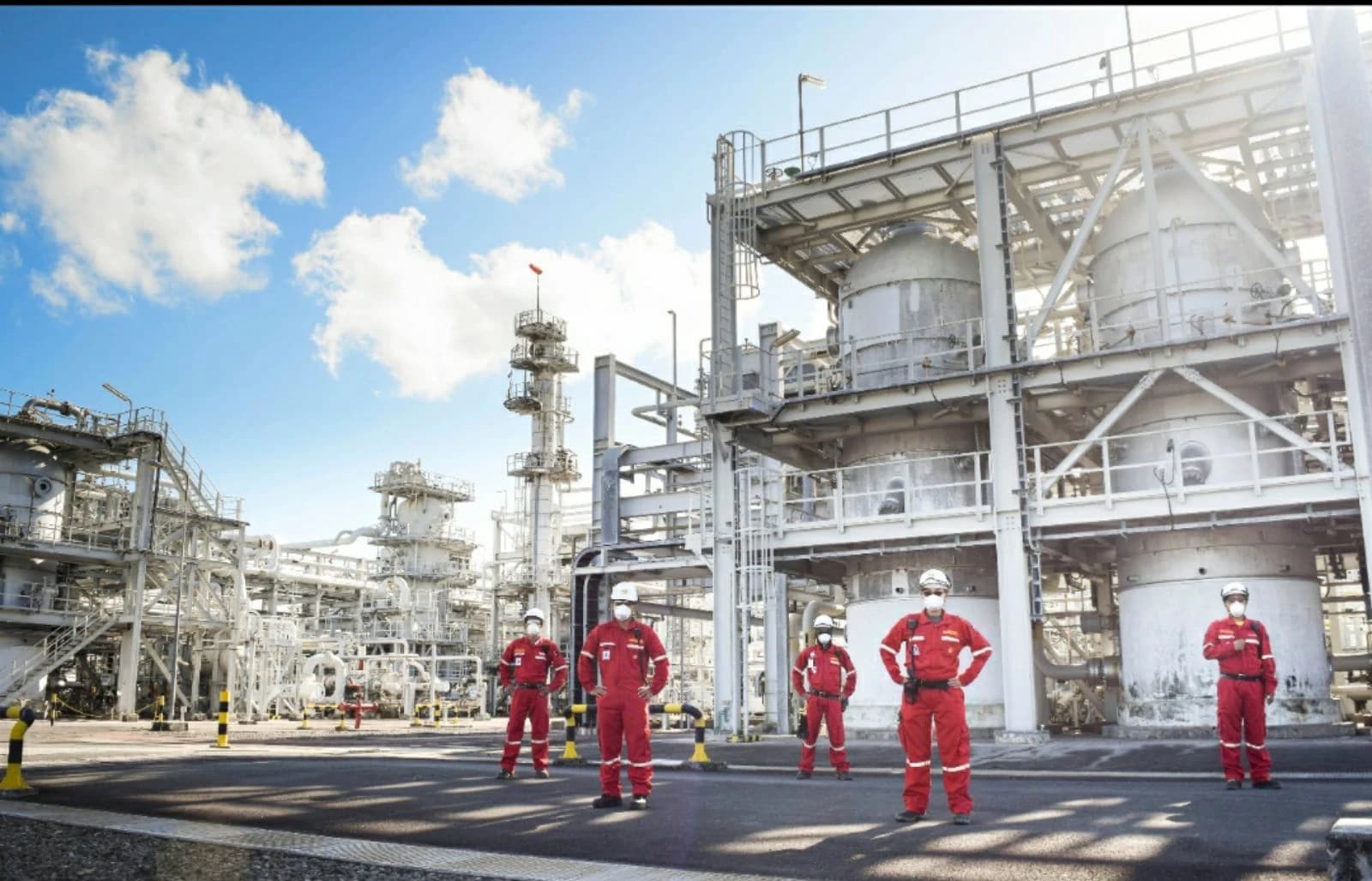 Gas plant workers in protective gear stand outside the Mlampaya Batangas Onshore Gas Plant.