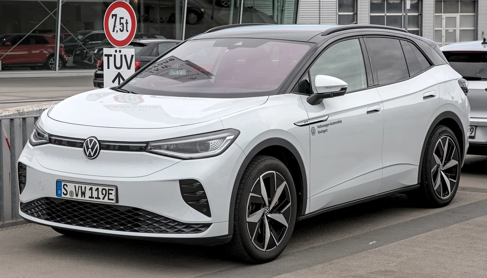 White Volkswagen ID.4 GTX electric SUV parked at an automotive facility.