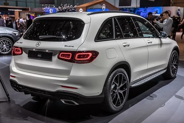 Rear view of a white Mercedes-Benz GLC 300 4MATIC SUV at a car show.