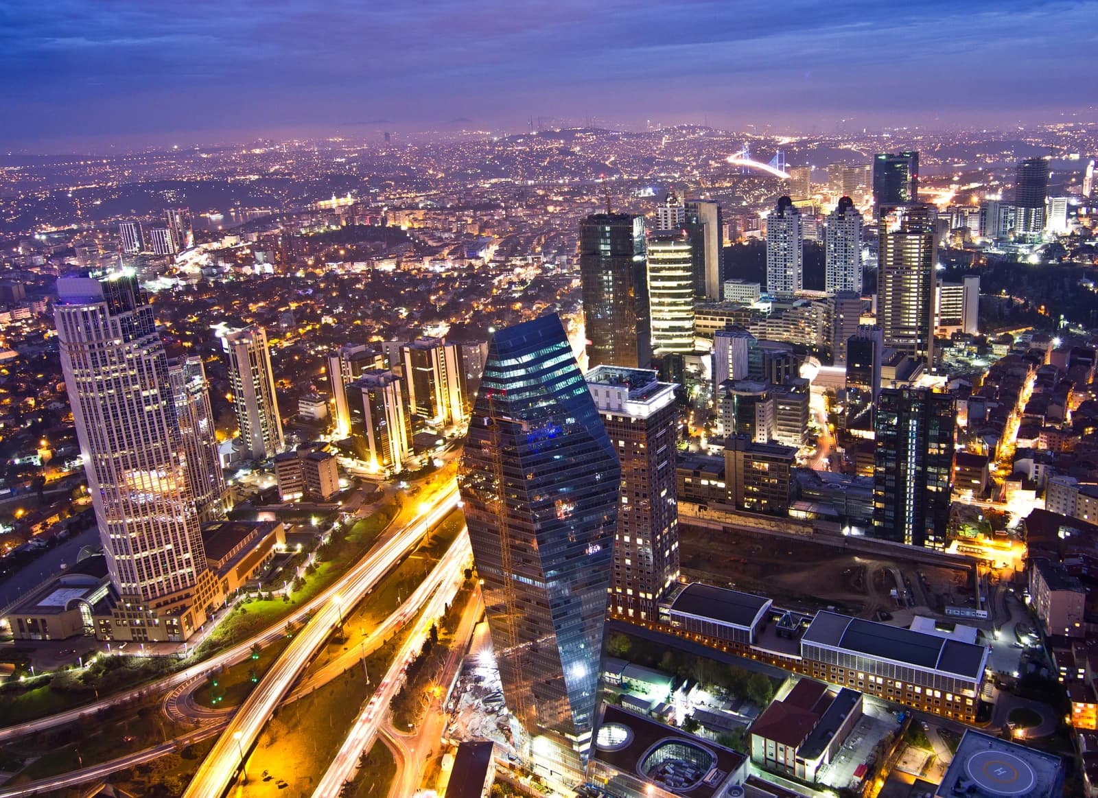 Aerial view of the illuminated Levent business district skyline in Istanbul at night.