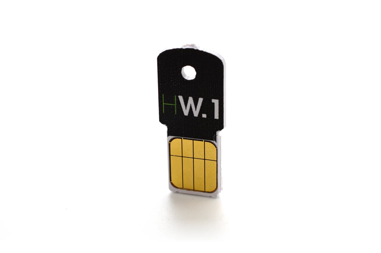 Ledger HW.1 hardware wallet, a small black and gold device, standing on white background.