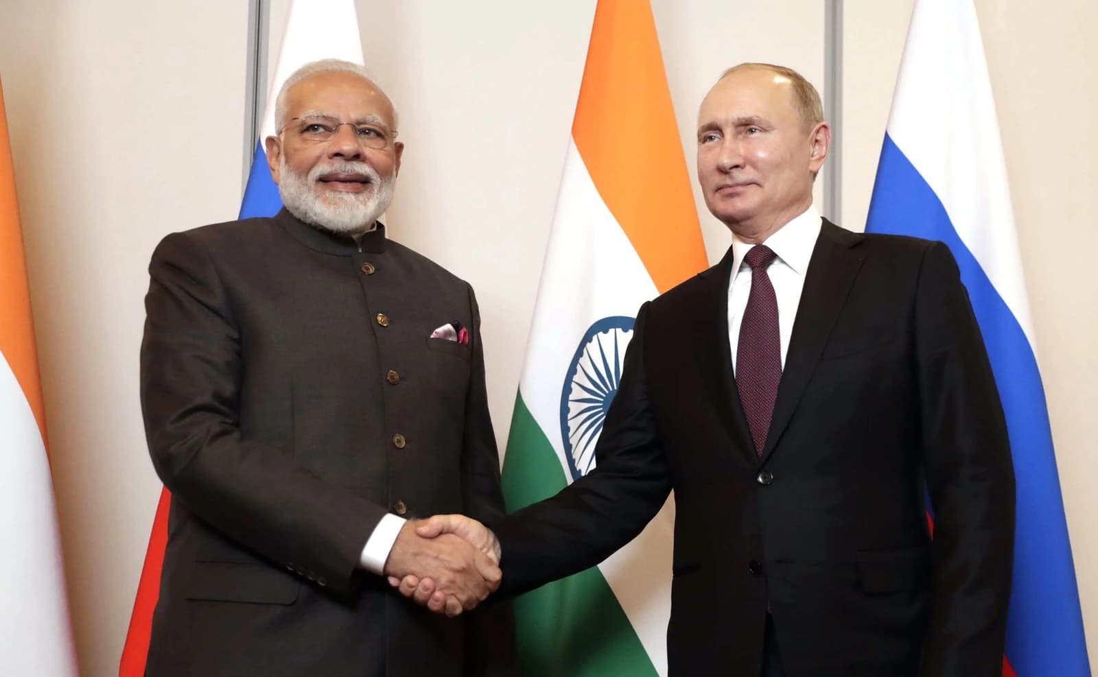 Russian President Vladimir Putin and Indian Prime Minister Narendra Modi shake hands.