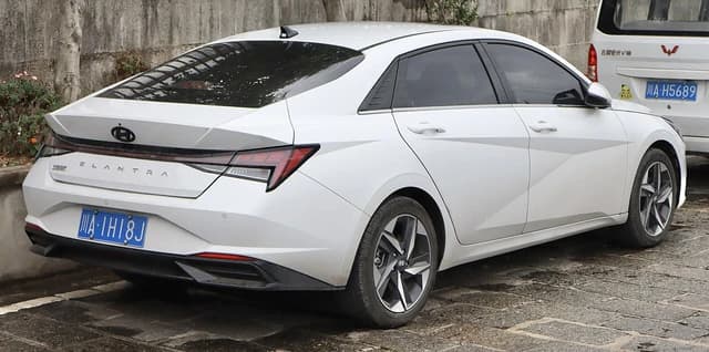 White 2020 Hyundai Elantra parked on a paved surface, seen from the rear.