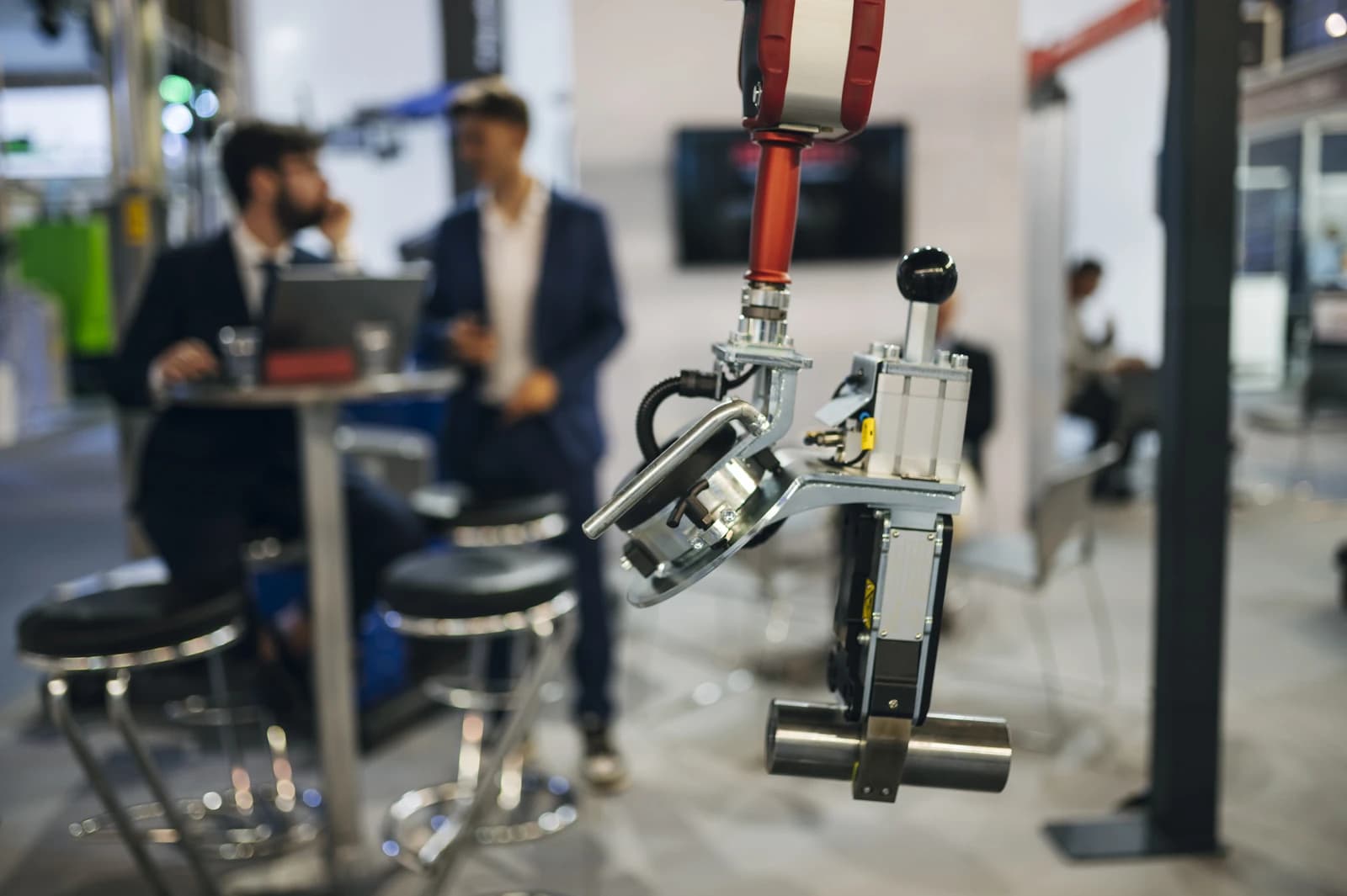 Robotic arm with a suction cup attachment at a technology exhibition.