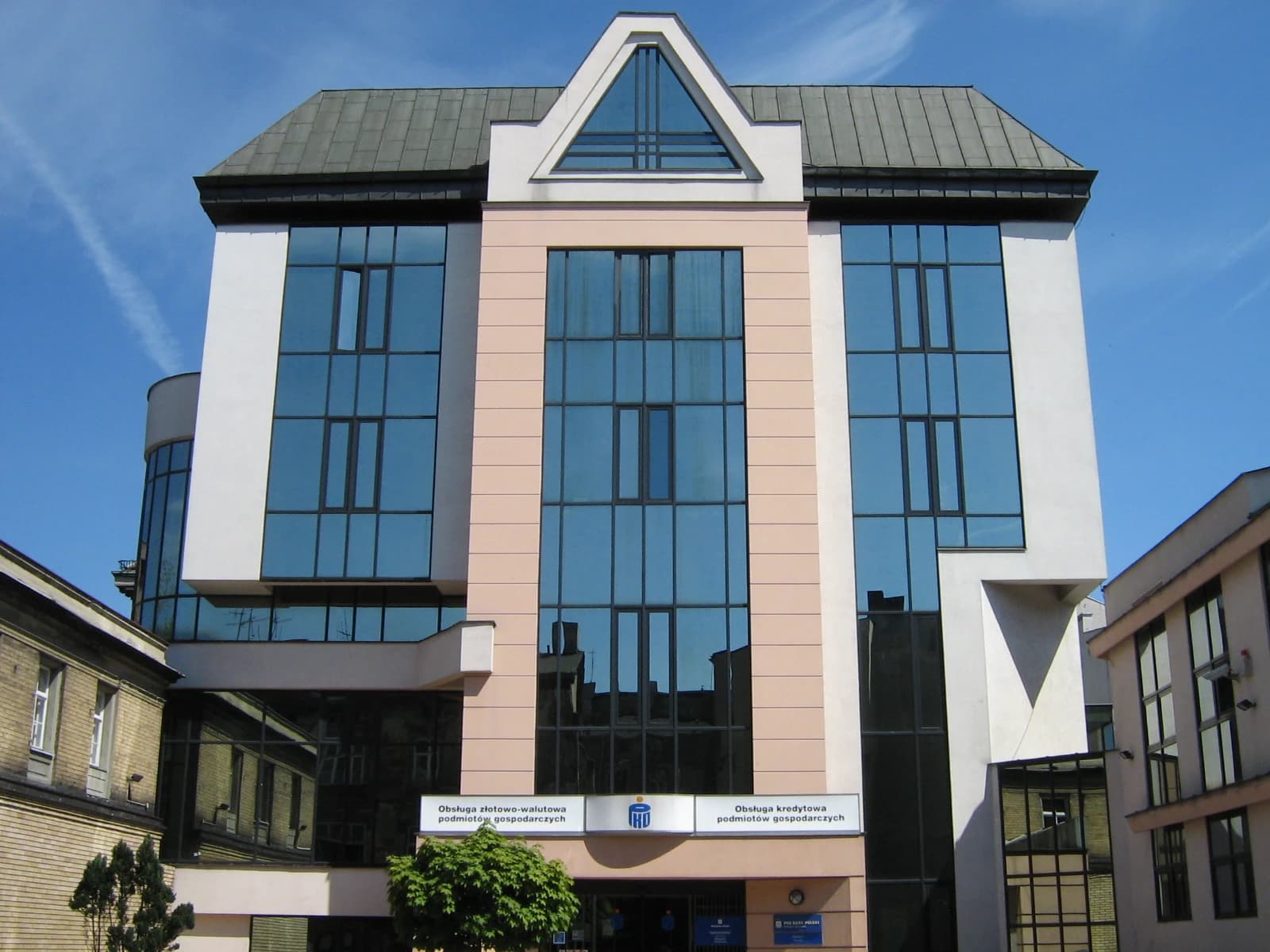 PKO Bank Polski building exterior with glass windows and a prominent triangular roof.