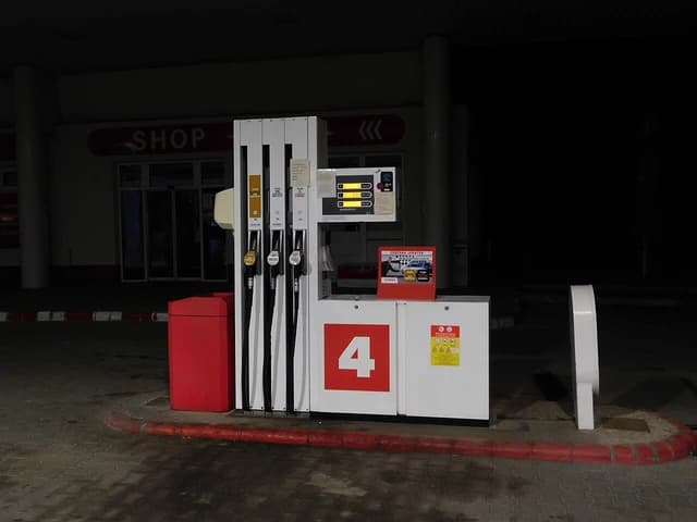 Gas pump at a Lukoil station with visible fuel limit notice.
