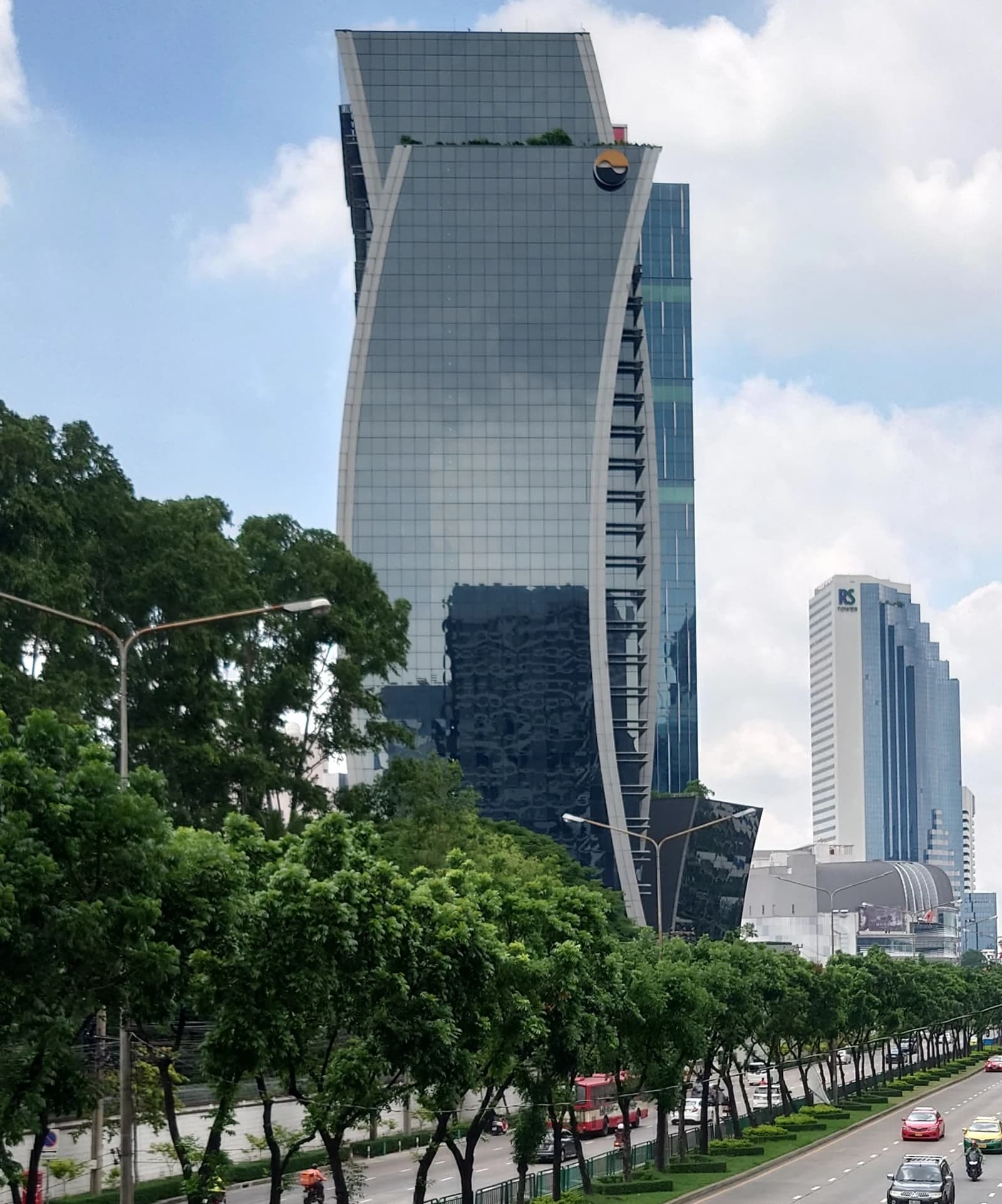 The modern glass facade of the Stock Exchange of Thailand building in Bangkok.