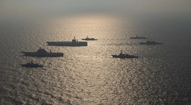 Ships from the Royal Australian Navy, Indian Navy, Japan Maritime Self-Defense Force, and United States Navy sailing in formation.