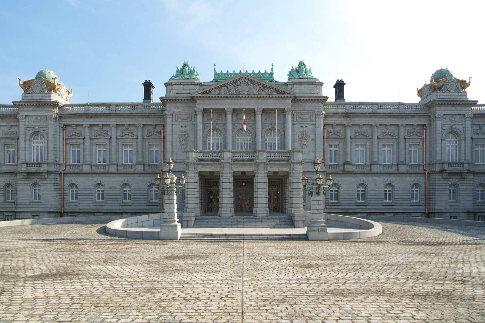 The State Guest House Akasaka Palace main entrance with a Japanese flag flying.
