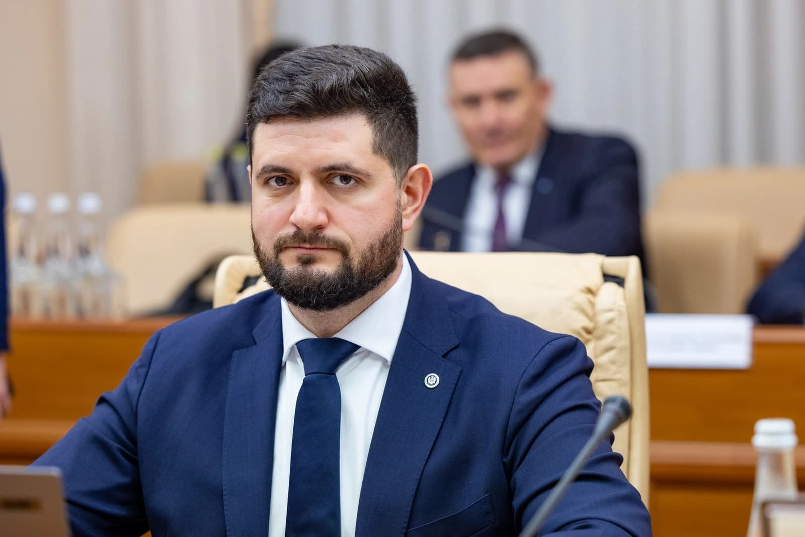 Dorin Junghietu, Minister of Energy of Moldova, seated at a conference table.