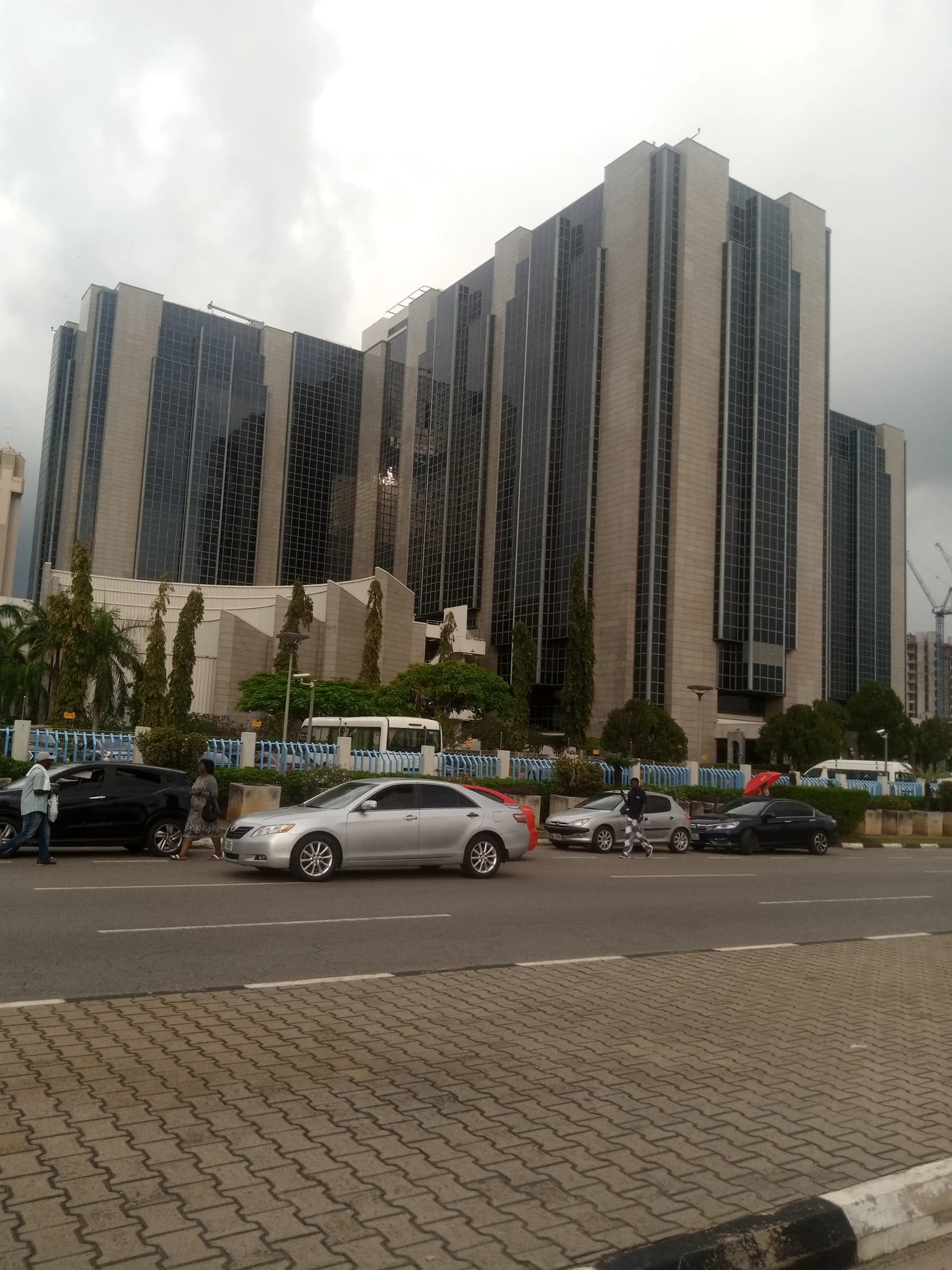 Central Bank of Nigeria building in Abuja, a modern high-rise glass and stone structure.
