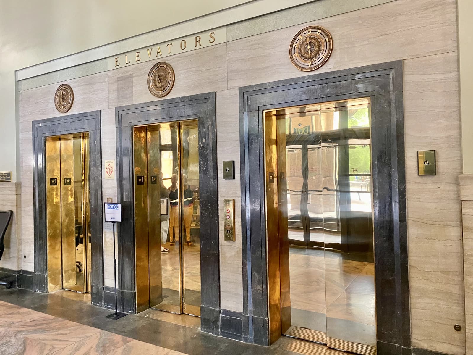 Three brass elevator doors at Asheville City Hall in North Carolina.