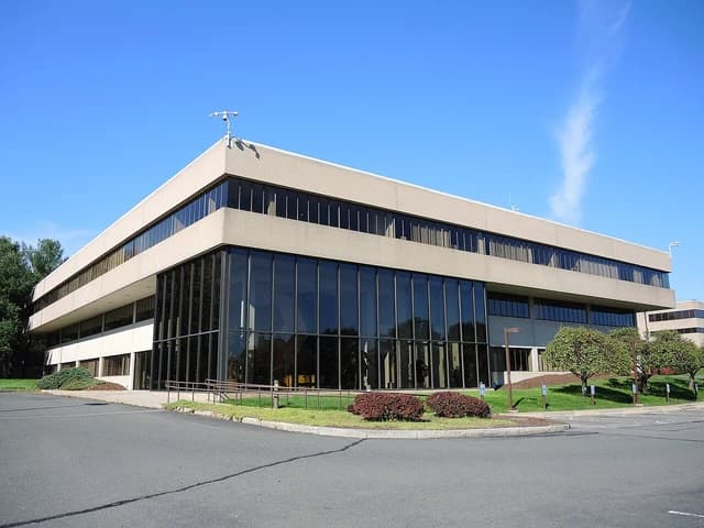 Exterior view of Otis Elevator Company headquarters building with large glass windows.