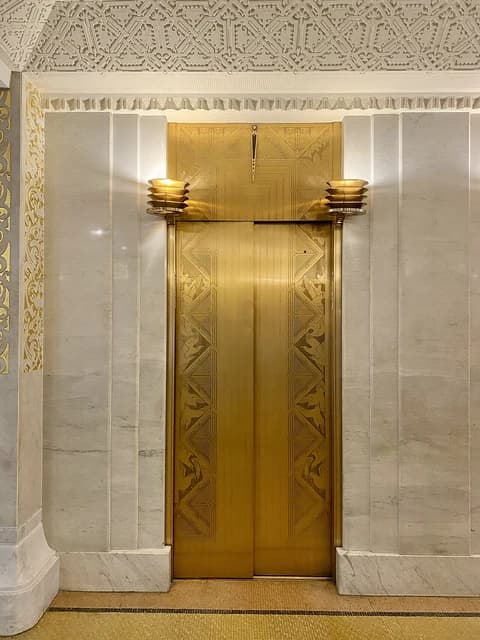 An ornate golden elevator door in the Rookery Building, Chicago.