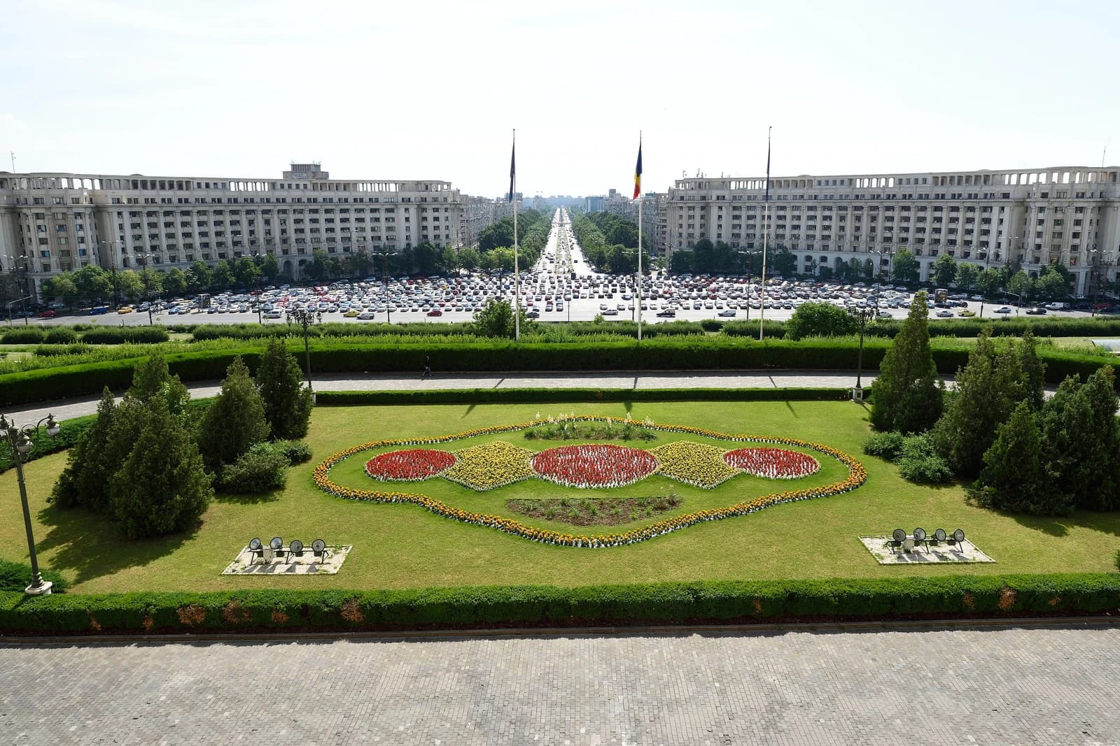 The Palace of the Parliament in Bucharest, Romania, with a garden in the foreground.