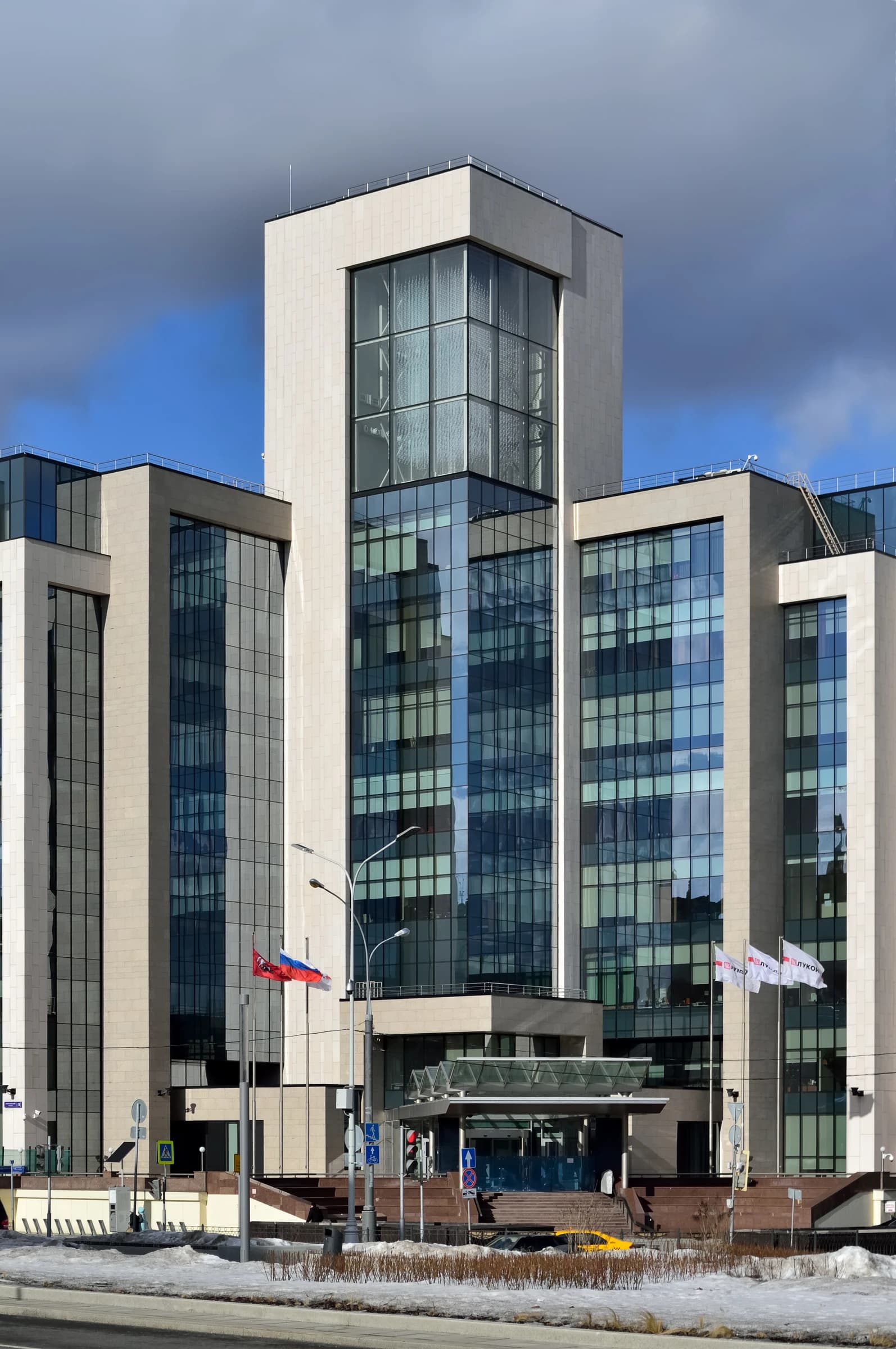 Building of Lukoil headquarters in Moscow with Russian flag and company flags.
