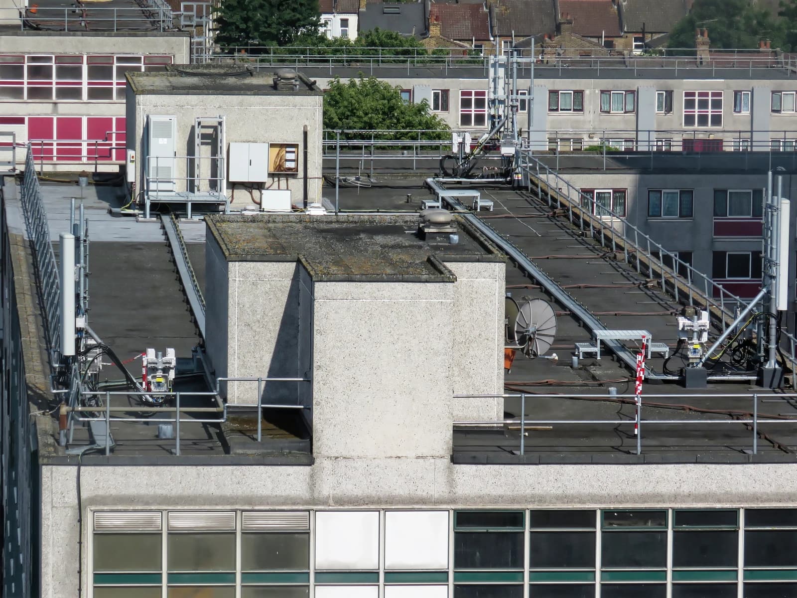 Cellular network antennas and mobile phone mounts installed on a rooftop.