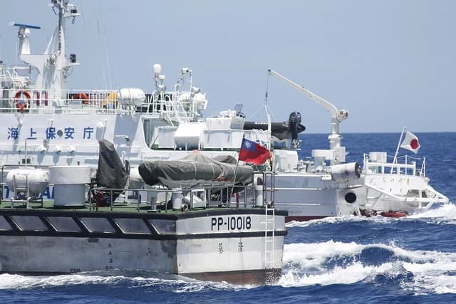 Taiwanese and Japanese Coast Guard ships underway in the ocean.