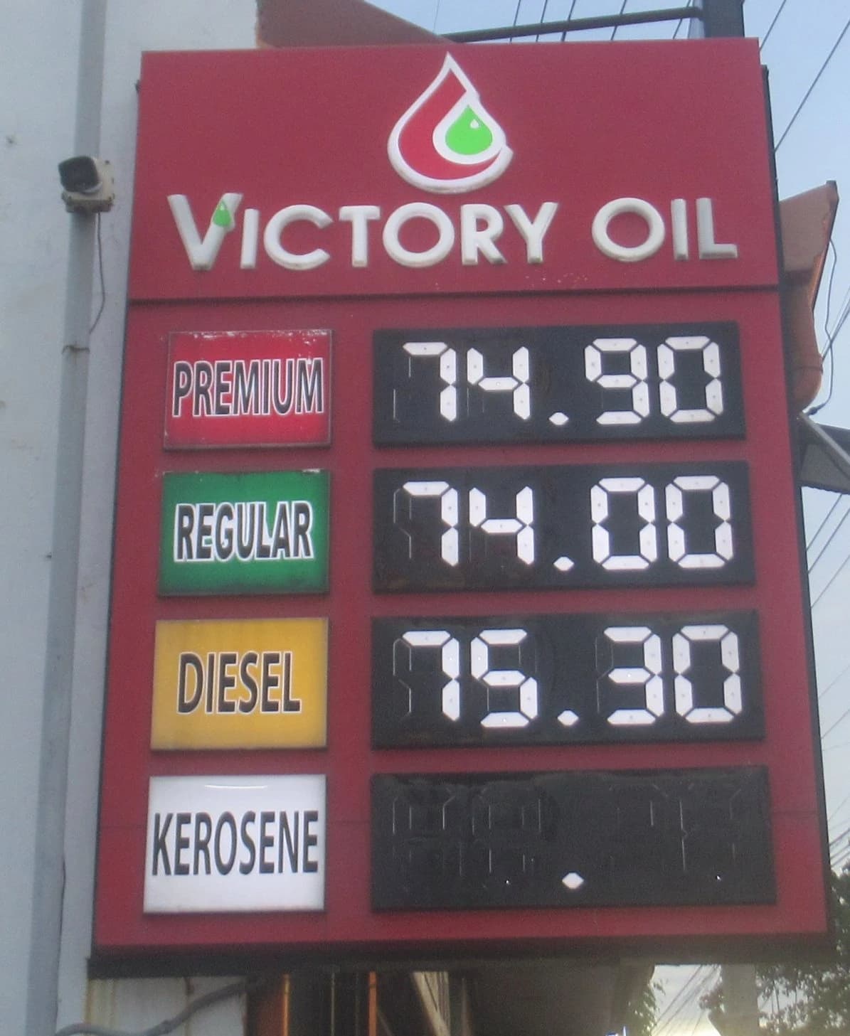 Victory Oil gas station price board displaying fuel prices for different types of fuel.