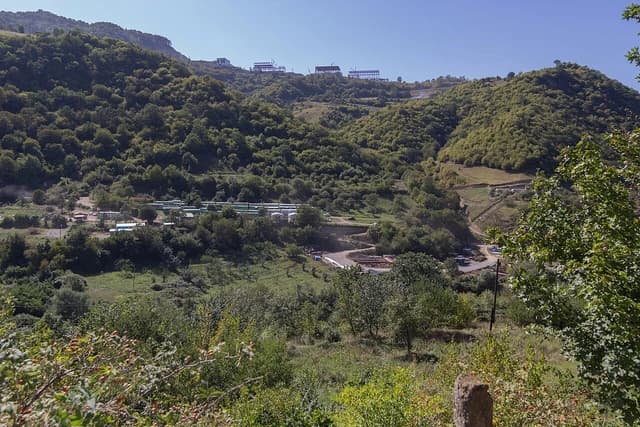 Overview of the Teghut Mine site in Armenia showing construction materials and quarters.