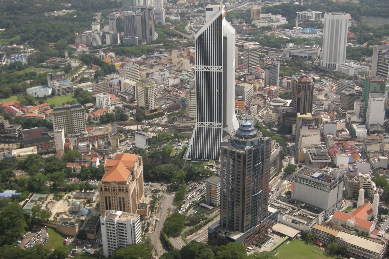 Aerial view of Kuala Lumpur city skyline featuring Maybank Tower.
