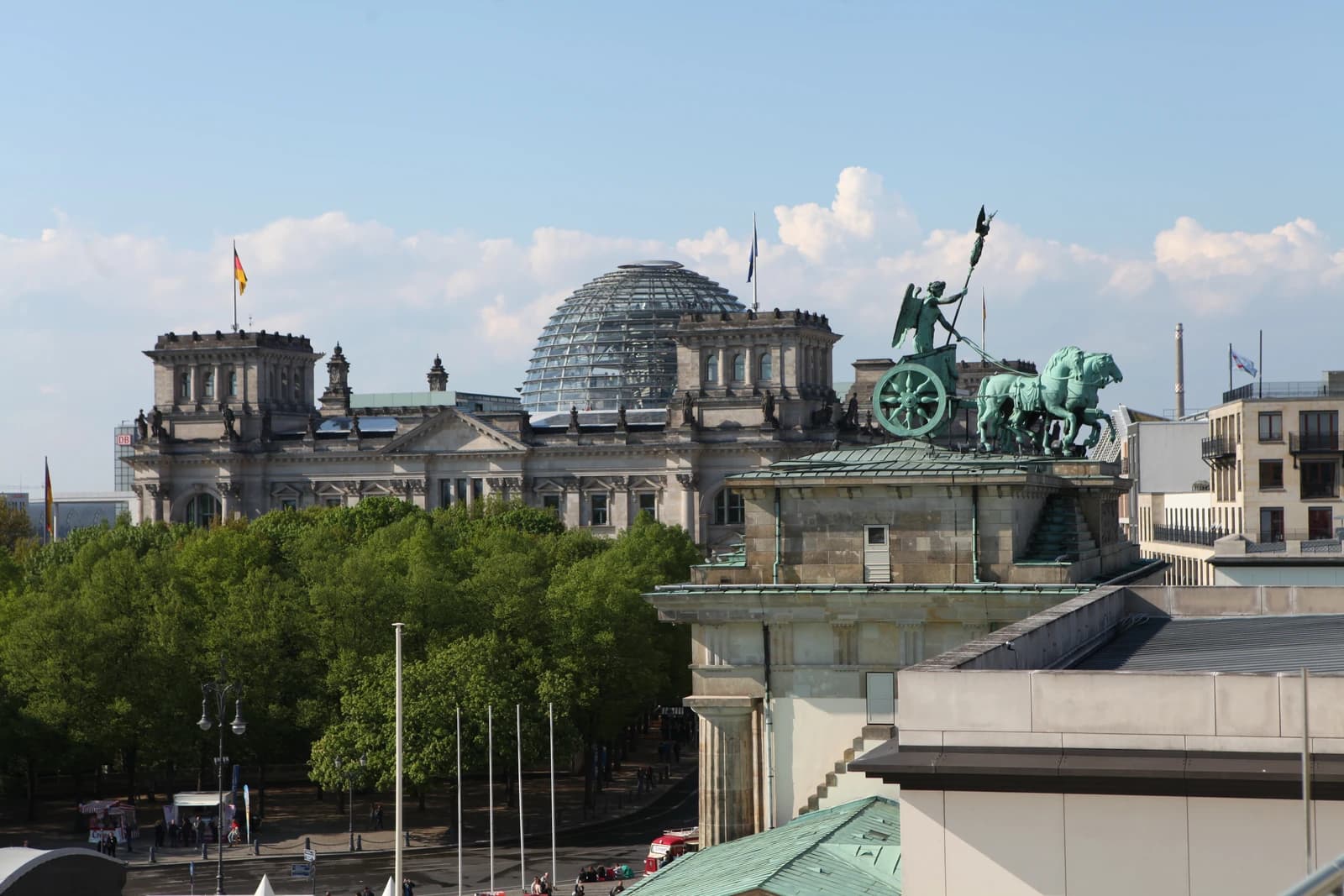 Reichstag Building with its glass dome and the Quadriga statue on the Brandenburg Gate in Berlin.