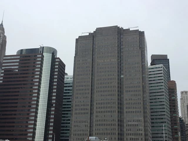 Lower Manhattan skyline featuring several tall buildings under an overcast January sky.