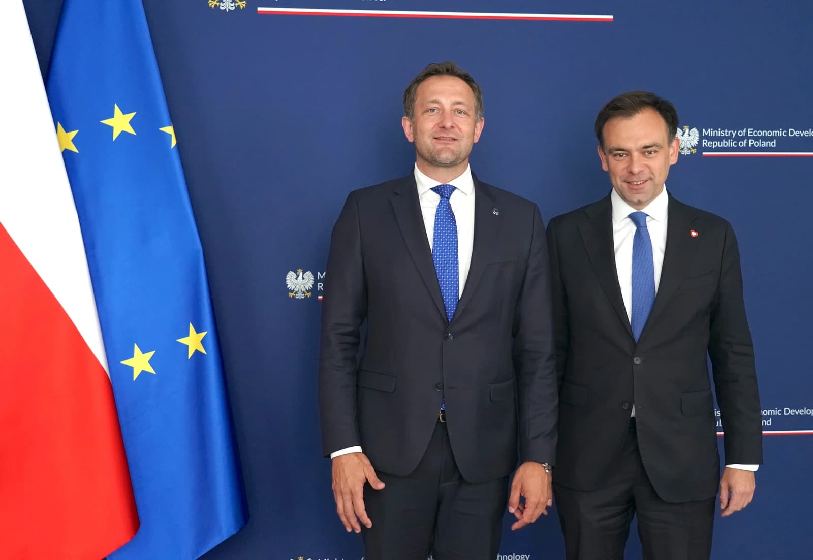 Christophe Hansen, Member of European Parliament, standing with a Polish official.