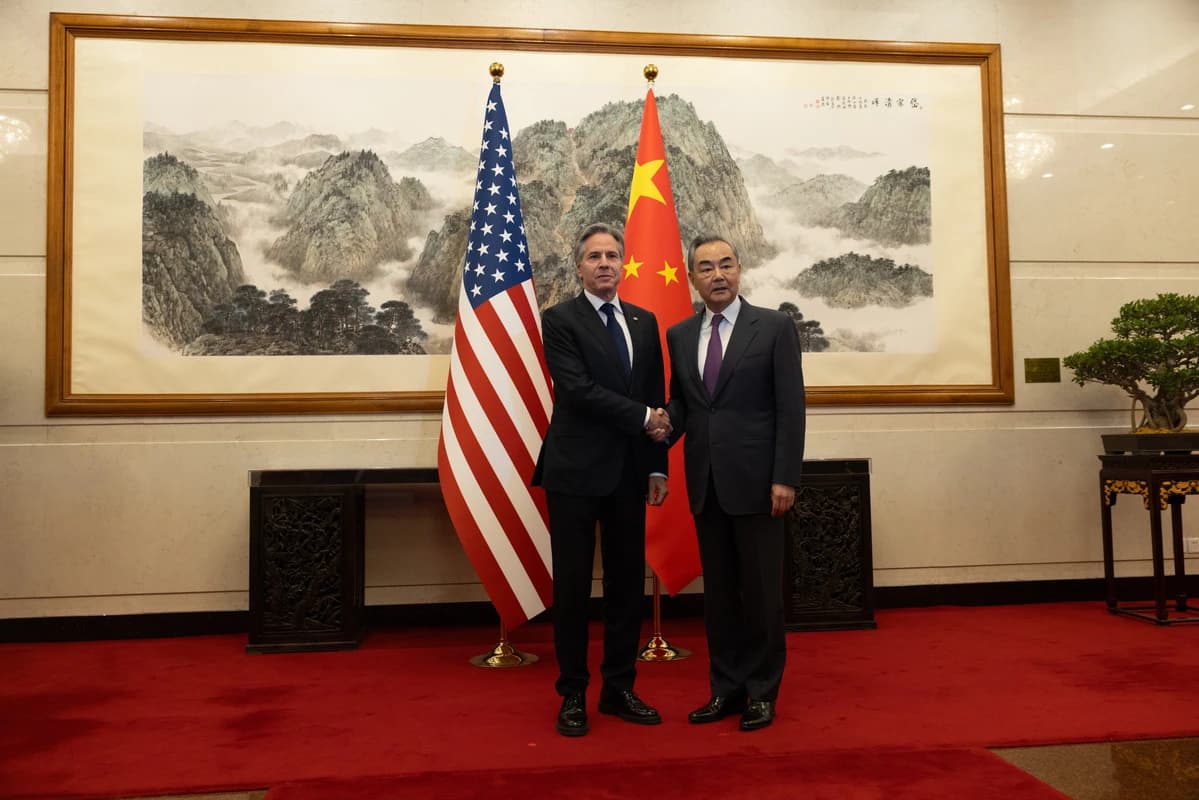 Secretary of State Antony Blinken shaking hands with Foreign Minister Wang Yi.