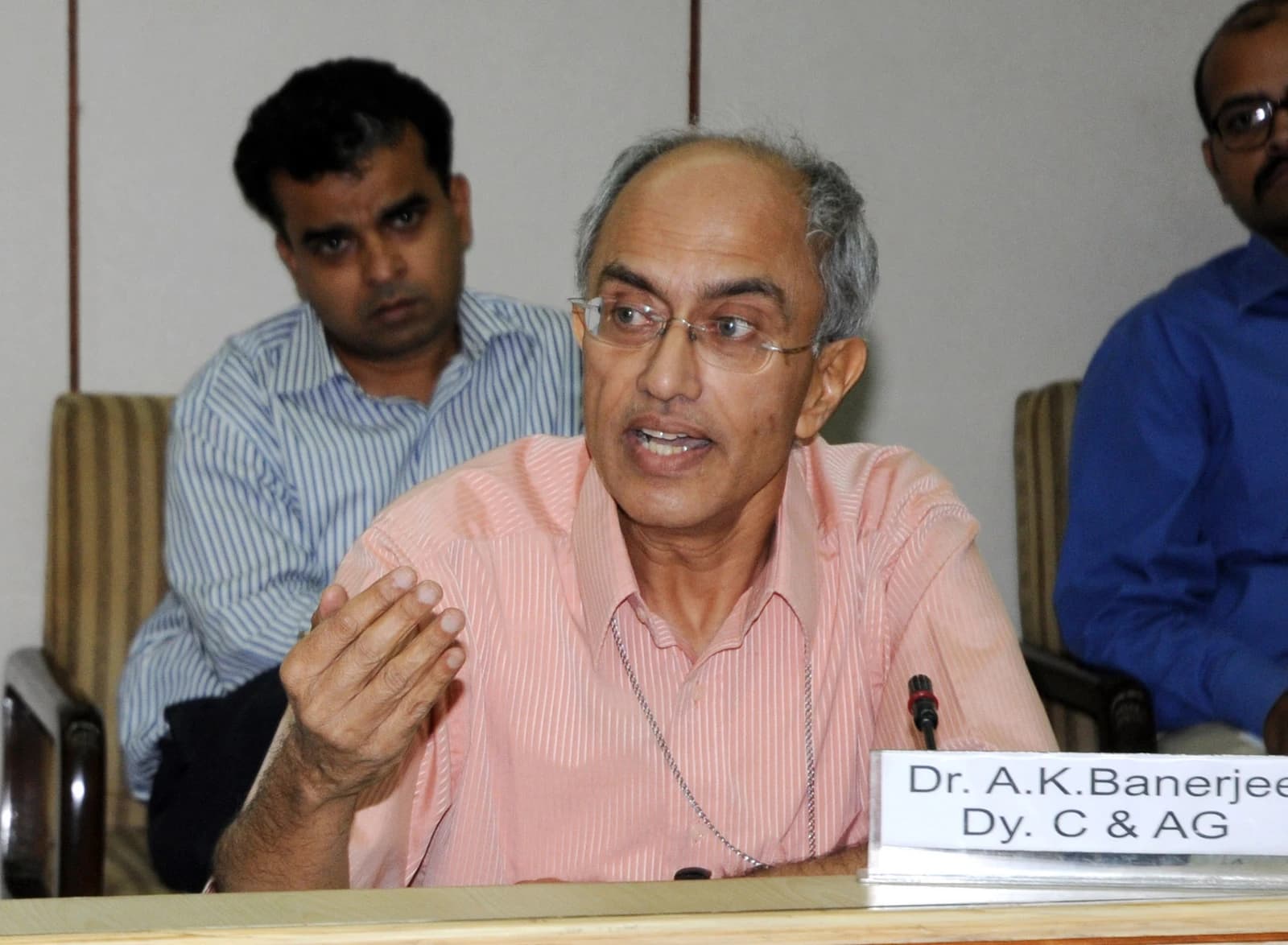 Dr. A.K. Banerjee, Dy. Comptroller and Auditor General, briefing press at a podium.