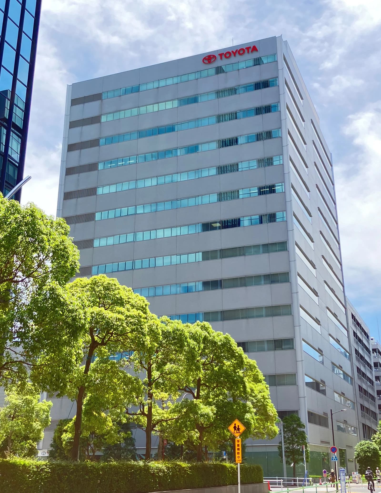 Toyota corporate building in Tokyo with the company logo visible on the facade.