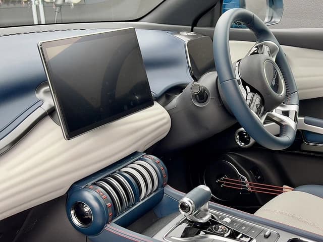 Interior of a BYD Atto 3 electric car showing dashboard, steering wheel, and gear selector.