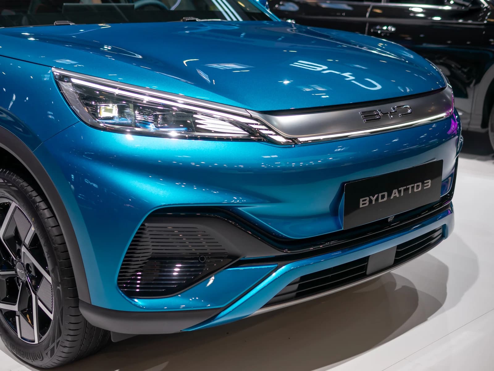 Front view of a blue BYD Atto 3 electric car at an automotive exhibition.