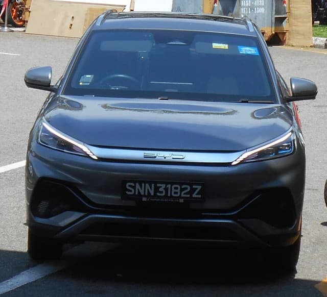 A gray BYD Atto 3 electric vehicle is parked, facing the camera, in daylight.