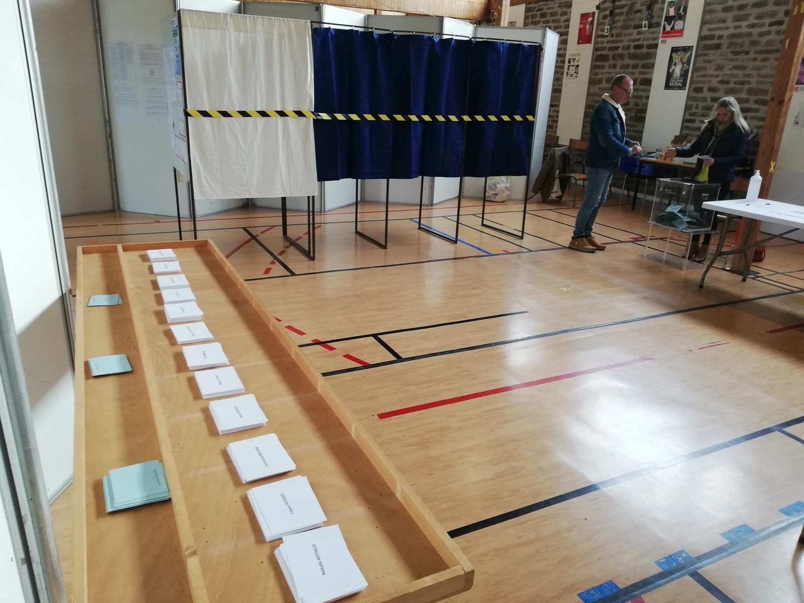 People casting ballots at a polling station during the 2022 French presidential election.