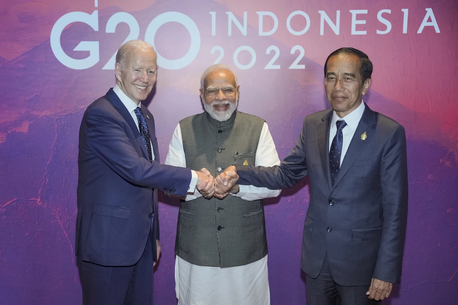 US President Joe Biden, Indian Prime Minister Narendra Modi, and Indonesian President Joko Widodo shaking hands.