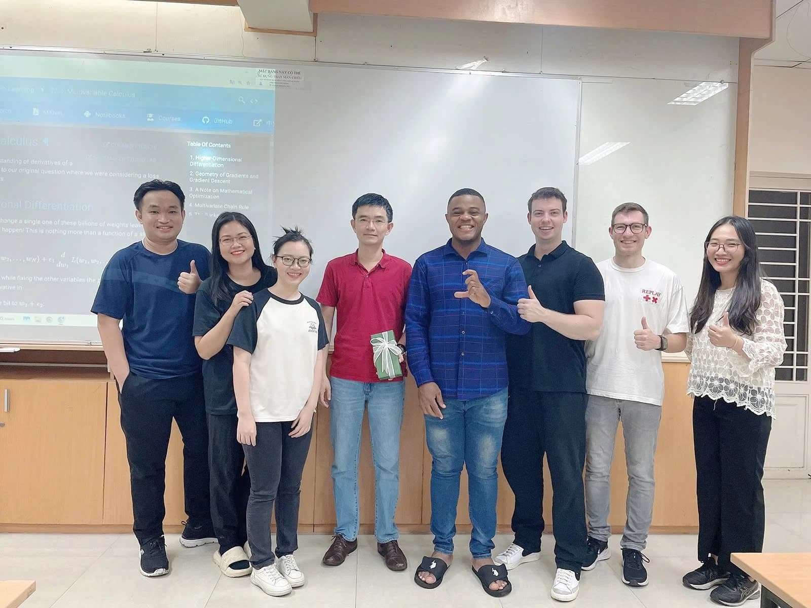 Justus Izuchukwu Onuh, a Master's student, posing with a group of people in a classroom.