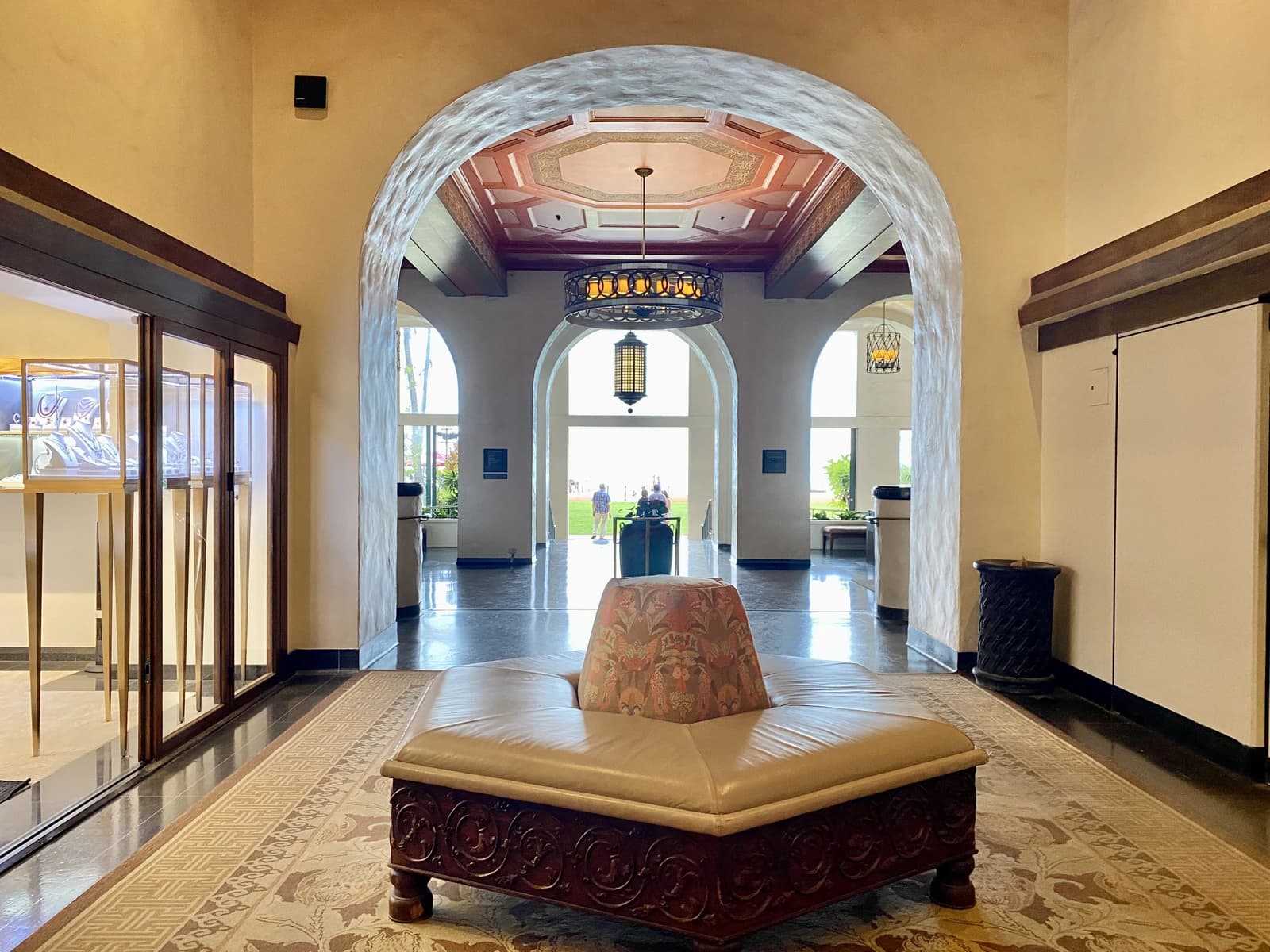 Lobby of the Royal Hawaiian Hotel, with archways leading to an outdoor area.
